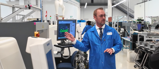 Derek showing the quality check process of the SMT line.